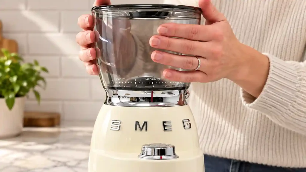 Twisting the bean hopper onto a coffee grinder base